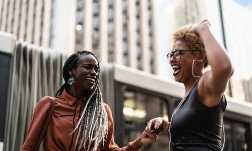 women laughing together in the city