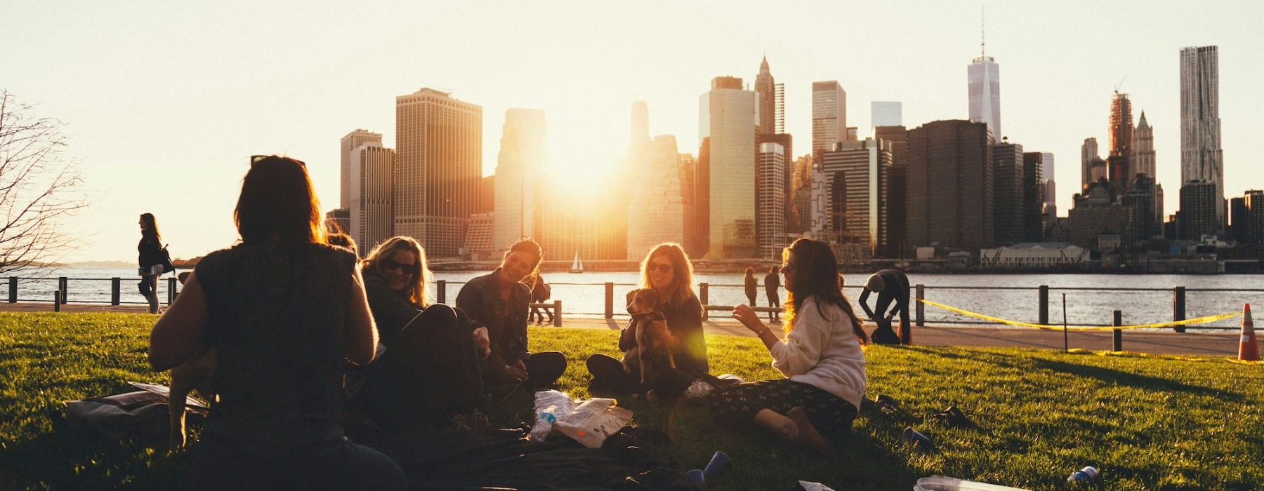 a group of friends having a picnic with the skyline of Chicago in the background